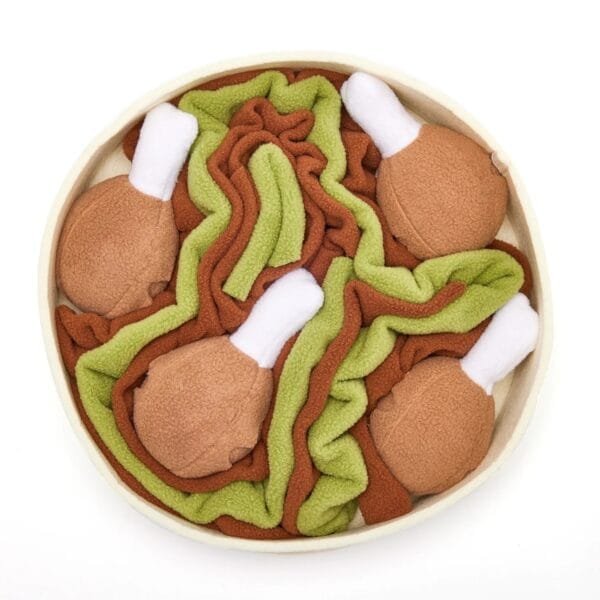 Injoya Chicken and Gravy snuffelschaal voor de hond Maximaal speel- en snuffelplezier met deze snuffel kip en juskom! De Injoya Chicken and Gravy snuffle bowl is niet alleen een super leuk hondenspeeltje, maar stimuleert ook nog eens de hersenen en zintuigen van jouw hond! Onder en in de kippenpoten, en in de bowl zelf, zijn verschillende verstopplekken voor snoepjes. Daarnaast kun je de kippenpoten ook los halen. Jouw hond kan dus maximaal spelen, snuffelen, zoeken en snoepen. De Injoya Chicken and Gravy snuffel bowl gaat verveling tegen en zet jouw hond mentaal aan het werk. Honden willen het liefste werken voor hun voer. Een goede manier om dat te doen is door brokjes te verstoppen in een snuffelspeeltje. Op die manier eten ze ook automatisch langzamer, wat weer beter is voor de spijsvertering. Snuffelspeelgoed stimuleert de zintuigen en de hersenen van de hond. Daarnaast werkt snuffelen en zoeken naar brokjes ontspannend en geeft het jouw hond voldoening. Tip: verstop de heerlijke snacks van Carniwell in deze bowl met kip, en snuffelen maar! Formaat Injoya Chicken and Gravy Snuffle Bowl: ø 27 cm, 7 cm hoog. Gemaakt van vilt en pluche en geschikt voor honden van alle leeftijden. Machine wasbaar op 30 graden. Hoe te gebruiken: Verwijder alle verpakking voor het gebruik. Gebruik de Injoya Chicken and Gravy Snuffle Bowl voor interactieve speeltijd. Met snuffelspeeltjes speel je samen met jouw hond. Jij verstopt de snacks in het speeltje, jouw hond gaat op zoek en jij helpt waar nodig. Laat jouw hond niet gefrustreerd raken en laat jouw hond op kalme wijze zoeken naar de snackies. Voor de hond is de combinatie van een zacht speeltje samen met het zoeken naar snacks een gouden combinatie. Is jouw hond meer van het kapotmaken van speeltjes? Dan haal je het speeltje na iedere snuffelsessie weg en berg je het op voor de volgende keer. Het speeltje is niet gemaakt om op te kauwen of aan te trekken. Niet onbeheerd in een bench of kamer achterlaten. Beschadigde of kapotte snuffelspeeltjes weghalen en vervangen. Injoya Hondenspeelgoed Maak kennis met Injoya, het merk dat staat voor kwaliteit, innovatie en eindeloos speelplezier voor uw hond! Injoya hondenspeelgoed is speciaal ontworpen om honden fysiek én mentaal te stimuleren. Van uitdagende snuffelmatten tot interactieve puzzelspeeltjes – elk product van Injoya is gemaakt met oog voor detail en gericht op het vervullen van de natuurlijke instincten van jouw hond. Mentale stimulatie voor honden De interactieve speeltjes van Injoya helpen honden mentaal scherp te blijven door ze uit te dagen en hun probleemoplossende vaardigheden te verbeteren. Het speelgoed is ontworpen om te voldoen aan het natuurlijke speur- en jaaginstinct van jouw hond, wat zorgt voor een voldaan en tevreden gevoel. Snuffelspeelgoed  Het speelgoed van Injoya biedt niet alleen fysiek vermaak, maar stimuleert ook de hersenen van uw hond. Interactieve speeltjes, zoals snuffelmatten en puzzels, dagen uw hond uit om te zoeken, te ruiken en oplossingen te vinden. Dit zorgt voor een voldane en tevreden hond. Natuurlijke Instincten Bevorderen Honden hebben van nature de behoefte om te snuffelen, jagen en problemen op te lossen. Het speelgoed van Injoya speelt perfect in op deze instincten. Zo help je jouw hond op een leuke manier zijn energie kwijt te raken en verveling te voorkomen. Snuffelmat voor honden De snuffelmatten van Injoya zijn ontworpen om de natuurlijke speurinstincten van honden te stimuleren en verveling tegen te gaan. Deze innovatieve matten bieden uw hond niet alleen eindeloos speelplezier, maar ook een waardevolle mentale uitdaging. Door snoepjes of brokjes in de mat te verstoppen, wordt jouw hond gestimuleerd om zijn neus en hersenen te gebruiken om het lekkers te vinden. Dit maakt snuffelmatten een ideaal hulpmiddel voor mentale stimulatie en gedragsverbetering. Bij A Lot for Doodles vind je een ruim assortiment aan hondenspeelgoed van Injoya. Bijvoorbeeld de Injoya snuffelmatten; ideaal voor het bevorderen van het zoekgedrag en mentale uitdaging. Injoya snuffelspeelgoed; voor honden die van een uitdaging houden en graag met hun pootjes of neus problemen oplossen. Hypoallergene hondensnacks Bij A Lot for Doodles vind je een ruim assortiment aan natuurlijke hypoallergene snacks van Carniwell. De snacks van Carniwell zijn graanvrij, er wordt niets aan toegevoegd en bevatten bovendien één eiwitbron. Hierdoor zijn de Carniwell snacks ook geschikt voor honden met allergieën, voedselintoleranties en voor honden die op dieet zijn. Bestel Injoy Hondenspeelgoed bij A Lot for Doodles Bestel je snuffelmatten en het snuffelspeelgoed van Injoya  eenvoudig bij A Lot for Doodles. Heb je vragen over onze producten of advies nodig wat je het beste kunt bestellen? Neem gerust contact met ons op, we helpen je graag verder.